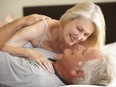 Senior Couple Relaxing On Bed Smiling to Each Other