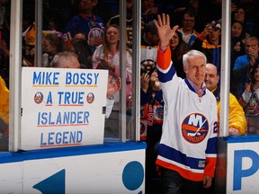 Former New York Islandes Mike Bossy waves to the crowd prior to the game duing Mike Bossy tribute Night  at the Nassau Veterans Memorial Coliseum on January 29, 2015 in Uniondale, New York.