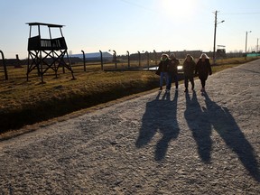 Visitors walk at the site of the former Nazi German concentration and extermination camp Auschwitz II-Birkenau, in Brzezinka near Oswiecim, Poland, March 13, 2022.