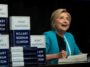 Former US Secretary of State Hillary Clinton signs copies of her new book 