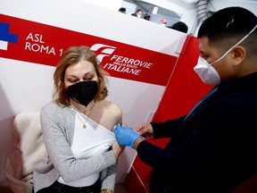 A woman receives a dose of the vaccine against COVID-19 at a Red Cross vaccination centre by Termini main train station in Rome, Italy, Jan. 10, 2022.