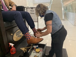 Lynn, with Penny Loafers Shoe Shine in First Canadian Place, works on Alex Gabrini's shoes.
