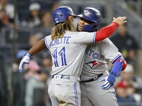 Blue Jays' Vladimir Guerrero Jr. celebrates his third-inning two-run home run against the Yankees with teammate Bo Bichette at Yankee Stadium on Wednesday, April 13, 2022 in New York.