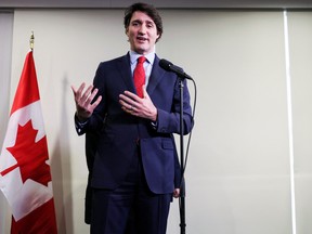 Canada's Prime Minister Justin Trudeau gestures as he speaks with the media as he highlights his government's new budget during a visit to Laval, Que, on April 13, 2022.