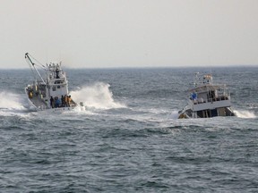 Fishing boats conduct a search operation for missing people aboard the "Kazu 1" sightseeing boat that went missing a day earlier, in the Sea of Okhotsk near Shari, Okhotsk Subprefecture of Hokkaido, Sunday, April 24, 2022.