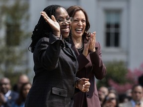 Judge Ketanji Brown Jackson smiles as Vice President Kamala Harris applauds at an event celebrating her confirmation to the U.S. Supreme Court on the South Lawn of the White House on April 8, 2022 in Washington, DC.
