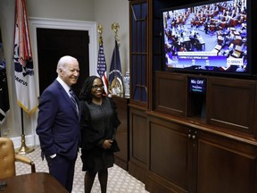 U.S. President Joe Biden and Judge Ketanji Brown Jackson watch together as the Senate votes to confirm her to be the first Black woman to be a justice on the Supreme Court in the Roosevelt Room at the White House in Washington, D.C., Thursday, April 7, 2022.