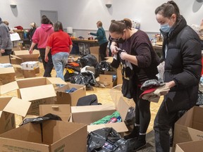 A volunteers collect, sort and box donations for the Ukrainian people at the London Ukrainian Centre in London, Ont., on March 3, 2022.