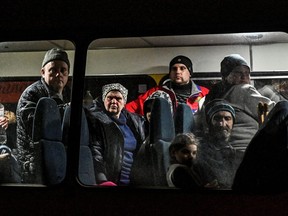 People who flee Mariupol and Melitopol as Russia’s attack on Ukraine continues, wait inside an evacuee bus at a collecting point in Zaporizhzhia, Ukraine April 1, 2022.