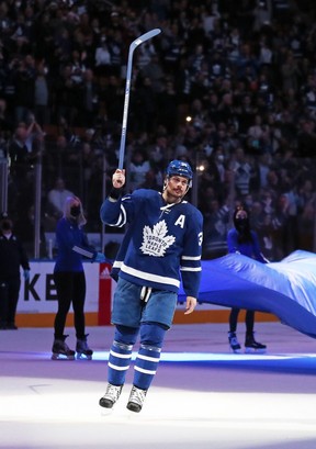 Maple Leafs centre Auston Matthews salutes the crowd after being named the game’s first star on Thursday. He scored his 50th goal into an empty net against the Winnipeg Jets. GETTY IMAGES