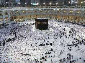 Muslims gather around the Kaaba, the holiest shrine in the Grand Mosque complex in the Saudi city of Mecca, ahead of prayers on the first day of the fasting month of Ramadan, on April 2, 2022.