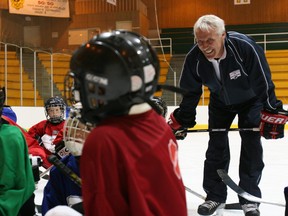 In this July 9, 2006 file photo, four-time Stanley Cup Champion Mike Bossy, far right, was at the Clare Drake Arena at the University of Alberta in Edmonton for an event to teach a group of young boys and girls the values of respect and responsibility in minor hockey.