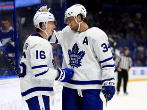 Winger Mitch Marner (left) celebrates a third-period goal with Auston Matthews against the Tampa Bay Lightning on Monday night at Amalie Arena. Marner has been instrumental in Matthews' road to 54 goals this season.