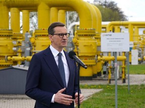 Polish Prime Minister Mateusz Morawiecki gives a press statement on the gas halt from Russia at the gas transmission point in Rembelszczyzna near Warsaw, Wednesday, April 27, 2022.