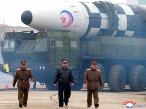 This file picture taken March 24, 2022 and released from North Korea's official Korean Central News Agency on March 25 shows North Korean leader Kim Jong Un walking near what a state media report says was a new type inter-continental ballistic missile before its test launch.