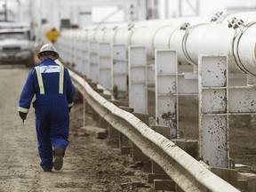 A worker walks along a pipeline at the Enbridge facility east of Edmonton in this file photo taken on May 16, 2008.