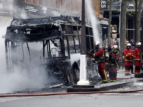 Firefighters work at the scene where a bus caught fire in Paris, France, April 4, 2022.