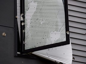 A broken window riddled with bullet holes is seen outside an Airbnb apartment rental in Pittsburgh, Sunday, April 17, 2022.