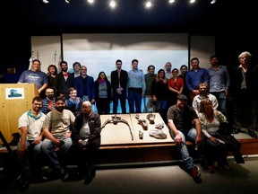 Argentine paleontologist Mauro Aranciaga Rolando poses with members of his team at the Buenos Aires National History Museum on April 27, 2022 next to the fossilized bones of a megaraptor dinosaur named Maip macrothorax that lived in the Patagonia region of Argentina.