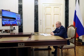 Russian President Vladimir Putin watches a test launch of the Sarmat intercontinental ballistic missile at Plesetsk cosmodrome in Arkhangelsk region, via video link in Moscow, Russia, April 20, 2022.