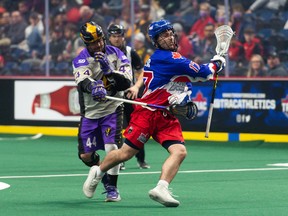 Aaron Forster (right) of the Toronto Rock tries to fend off a San Diego Seals player on Saturday night in Hamilton.