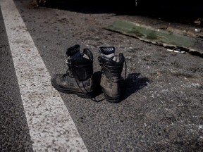 Boots of a Russian soldier are seen outside a Russian artillery vehicle that Ukraine captured during fighting outside Kharkiv, Ukraine, March 29, 2022.