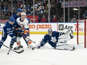 Maple Leafs' Timothy Liljegren battles in front of goaltender Jack Campbell with New York Islanders' Anthony Beauvillier during the second period at Scotiabank Arena on Sunday, April 17, 2022.