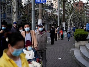Residents line up for a nucleic acid test during a lockdown to curb the spread of the coronavirus in Shanghai, China April 9, 2022.