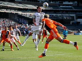 Apr 24, 2022; New York, NY, New York, NY, USA; Toronto FC defender Shane O'Neill plays the ball against New York City FC midfielder Valentin Castellanos during the first half at Citi Field.