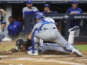 Toronto Blue Jays catcher Tyler Heineman tags out New York Yankees third baseman Josh Donaldson in the first inning at Yankee Stadium on April 12, 2022.