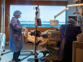 ICU doctor Jamie Spiegelman speaks to a COVID-19 patient before intubation, at Humber River Hospital in Toronto, Jan. 20, 2022.