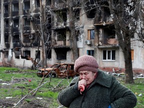 Local resident Tamara, 71, cries in front of an apartment building destroyed during Ukraine-Russia conflict in the southern port city of Mariupol, Ukraine April 19, 2022.