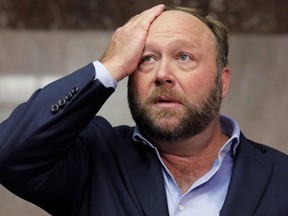 Alex Jones of Infowars talks to the media while visiting the U.S. Senate's Dirksen Senate office building as Twitter CEO Jack Dorsey testifies before a Senate Intelligence Committee hearing on Capitol Hill in Washington, Sept. 5, 2018.