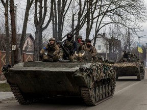 Ukrainian soldiers are seen on tanks, amid Russia's invasion of Ukraine, in Bucha, Ukraine, Wednesday, April 6, 2022.