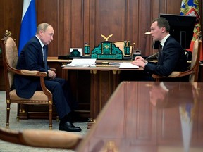 Russian President Vladimir Putin attends a meeting with Governor of Khabarovsk Region Mikhail Degtyaryov in Moscow, Thursday, April 28, 2022.