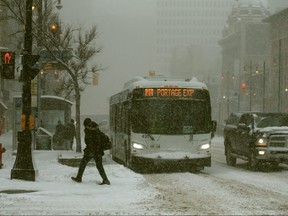 Downtown Winnipeg is pictured during a spring snowstorm on April 13, 2022.