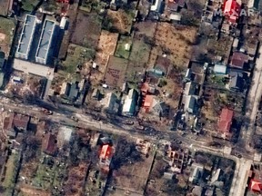 A satellite image shows destroyed homes and armored vehicles along Vokzalna Street , in Bucha, Ukraine, March 31, 2022.