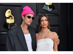 Canadian performer Justin Bieber (L) and his wife, model Hailey Bieber, are pictured as they arrive for the 64th Annual Grammy Awards at the MGM Grand Garden Arena in Las Vegas on April 3, 2022.