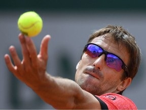 In this file photo taken on May 31, 2017 Spain's Tommy Robredo serves the ball to Bulgaria's Grigor Dimitrov during their tennis match at the Roland Garros 2017 French Open in Paris.