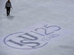 Volunteers fix the ice next to an International Skating Union (ISU) logo during the ice dance/short dance event at the ISU World Figure Skating Championships in Helsinki, Finland on March 31, 2017.
