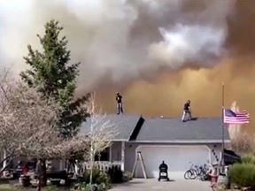 In this screengrab taken from a Reuters video, firefighters battle a rapidly growing wildfire in central Arizona that has already driven thousands of residents from their homes and destroyed two dozen structures on Wednesday, April 20, 2022.