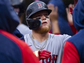 Apr 13, 2022; Detroit, Michigan, USA; Boston Red Sox left fielder Alex Verdugo (99) celebrates with teammates after hitting a sacrifice fly during the fourth inning against the Detroit Tigers at Comerica Park.