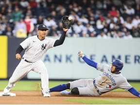 Apr 11, 2022; Bronx, New York, USA; New York Yankees second baseman Gleyber Torres (left) forces out Toronto Blue Jays center fielder George Springer (right) at second base in the first inning at Yankee Stadium