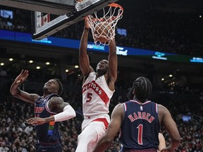 Toronto Raptors forward Precious Achiuwa  dunks the ball against Philadelphia 76ers forward Paul Reed  and guard James Harden during the second half of game three of the first round for the 2022 NBA playoffs at Scotiabank Arena.