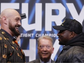 Tyson Fury and Dillian Whyte pose as promoter Frank Warren looks on after the press conference.