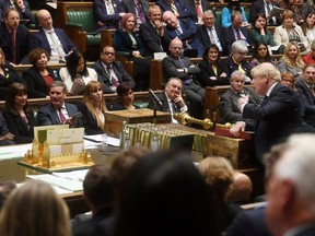 British Prime Minister Boris Johnson speaks across the floor from Labour Party opposition leader Keir Starmer during Prime Minister's Questions at the House of Commons in London, April 20, 2022.