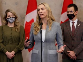 Canada's Minister of Sport Pascale St-Onge, with Minister of Foreign Affairs Melanie Joly and Parliamentary Secretary to the Minister of Sport Adam van Koeverden, speaks during a press conference on Parliament Hill in Ottawa, Ontario, Canada, December 8, 2021.