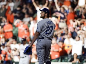 Los Angeles Dodgers starting pitcher Trevor Bauer watches the solo home run of Houston Astros' Jose Altuve during the first inning of a baseball game, Wednesday, May 26, 2021, in Houston.