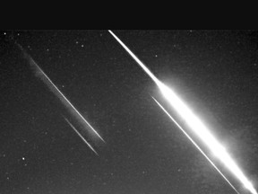 A fireball (brightest light) observed by the CA000P Global Meteor Network camera in Bowmanville. Additional streaks are lens reflections. (Photo by Miguel Preciado)