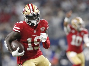 San Francisco 49ers wide receiver Deebo Samuel runs for a touchdown after catching a pass in the third quarter against the Dallas Cowboys in a NFC Wild Card playoff football game at AT&T Stadium.